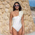 One shoulder white pomps